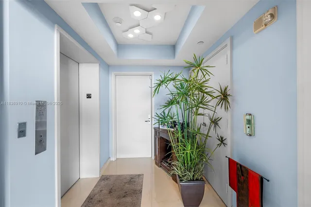 a living room with stainless steel appliances kitchen island granite countertop a table chairs in it and a flat screen tv