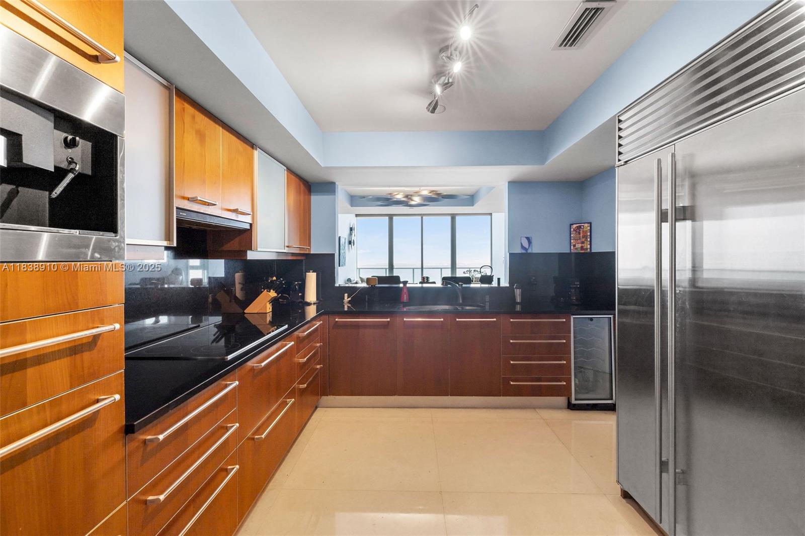 1331 Brickell Bay Drive, Unit 2909 Miami, FL 33131 - Photo 16 of 48 a kitchen with stainless steel appliances granite countertop a refrigerator and a stove top oven