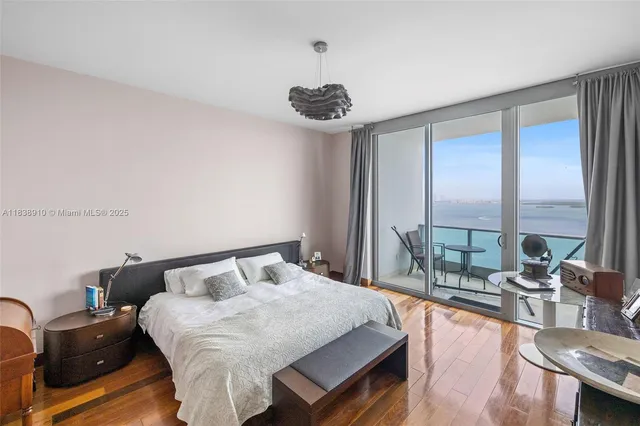 a bedroom with a bed and a large window