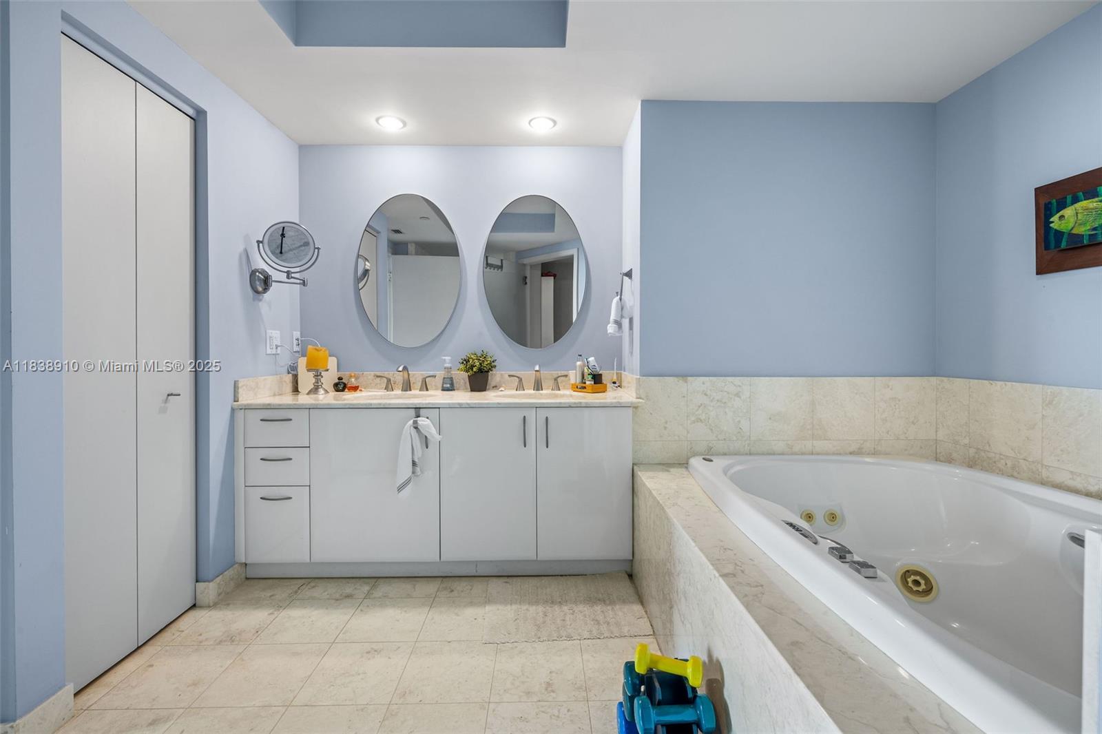 1331 Brickell Bay Drive, Unit 2909 Miami, FL 33131 - Photo 23 of 48 a bathroom with a bathtub a double vanity sink and a mirror