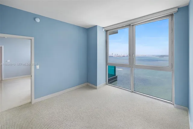 a view of an empty room with glass doors