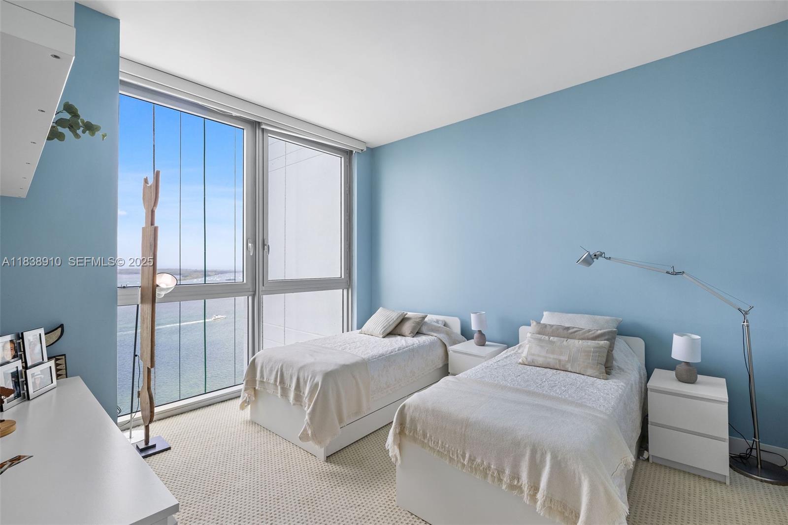 1331 Brickell Bay Drive, Unit 2909 Miami, FL 33131 - Photo 29 of 48 a bedroom with two beds and large window