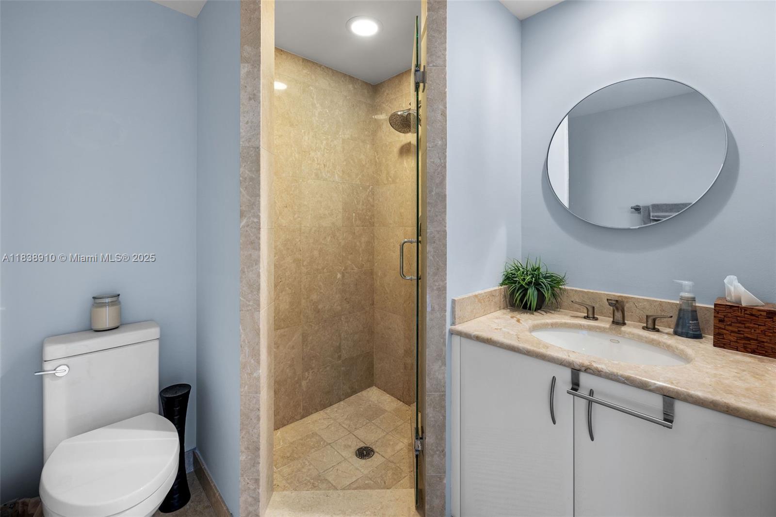 1331 Brickell Bay Drive, Unit 2909 Miami, FL 33131 - Photo 31 of 48 a bathroom with a granite countertop sink toilet and shower