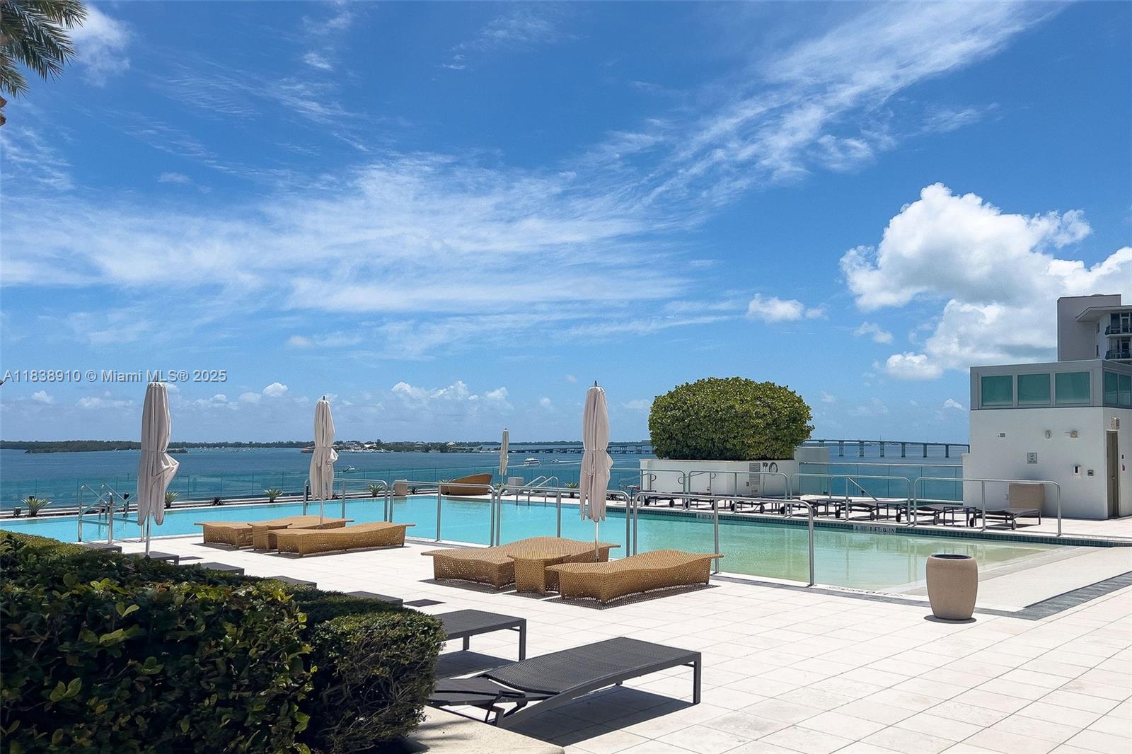 1331 Brickell Bay Drive, Unit 2909 Miami, FL 33131 - Photo 39 of 48 a view of a swimming pool with a patio and dining table