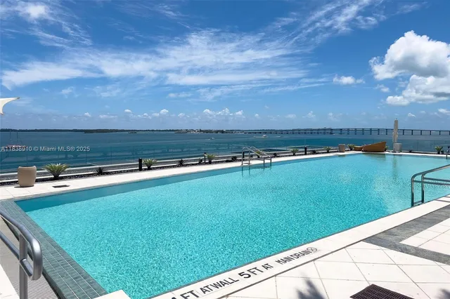 a view of a swimming pool with a yard