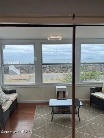 a living room with a table and a large window