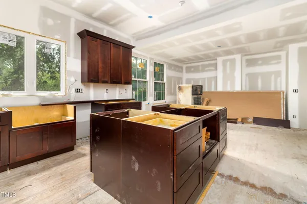 a view of kitchen with furniture and windows