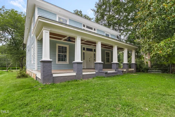 a view of a house with a backyard and a patio