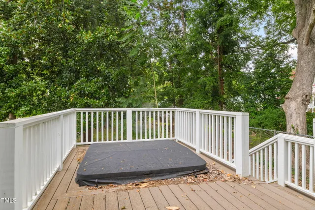 a balcony with wooden floor and fence