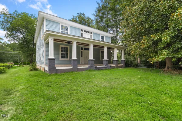 a front view of house with yard and outdoor seating