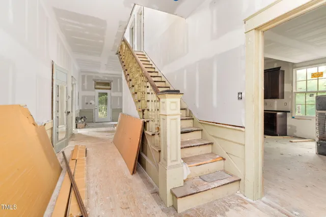 a view of entryway and hall with wooden floor
