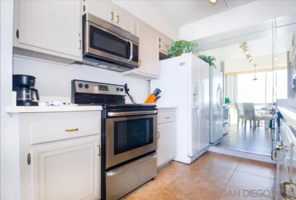 a kitchen with stainless steel appliances a stove microwave and a refrigerator
