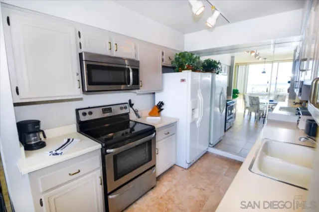 a kitchen with stainless steel appliances a stove microwave and a refrigerator