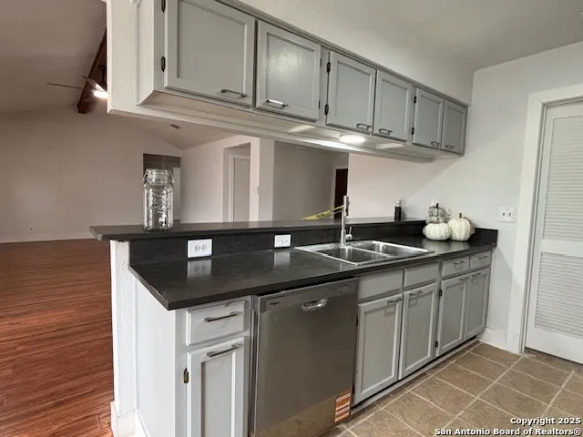 a kitchen with stainless steel appliances granite countertop a sink and cabinets