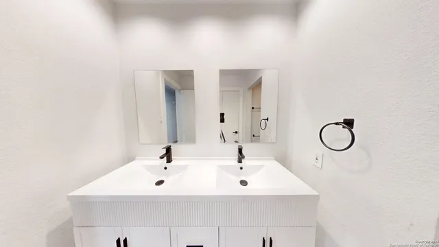 a view of a big room with wooden floor and windows