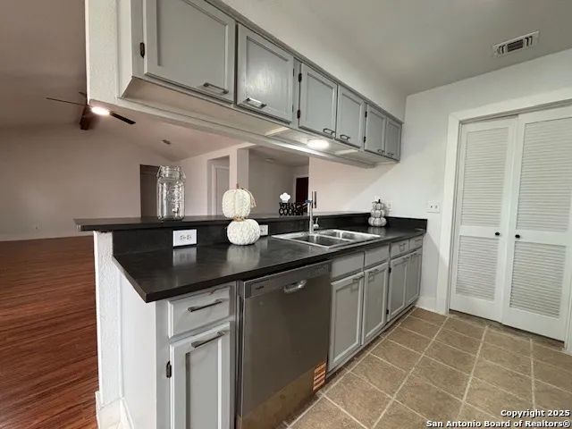 a kitchen with stainless steel appliances granite countertop a sink and cabinets