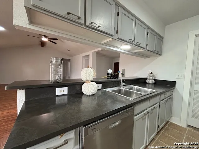a kitchen with kitchen island stainless steel appliances a sink and cabinets