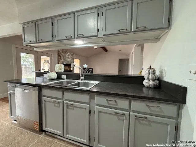 a kitchen with stainless steel appliances granite countertop a sink and cabinets