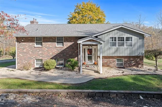 a front view of a house with garden