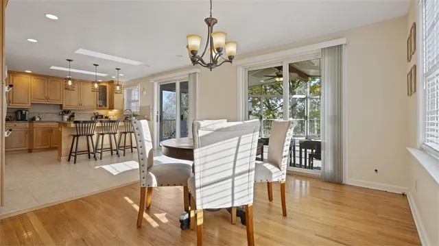 a view of a dining room with furniture wooden floor and chandelier