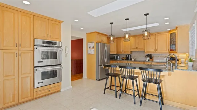 a kitchen with stainless steel appliances a refrigerator and a stove top oven