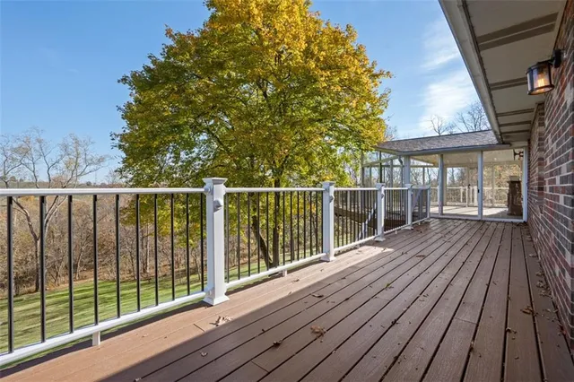a view of balcony with wooden floor and fence