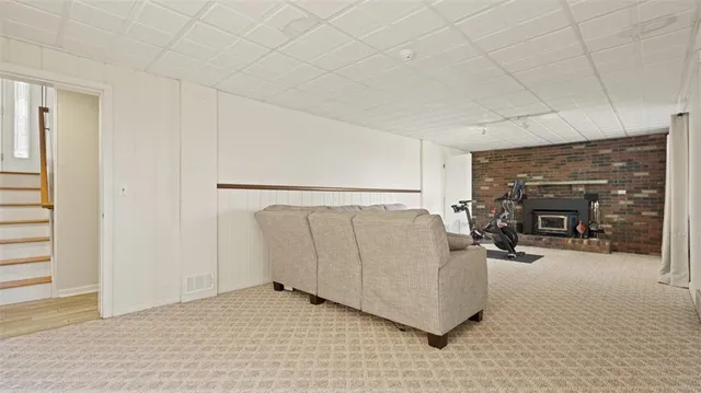 a view of a livingroom with furniture and a fireplace