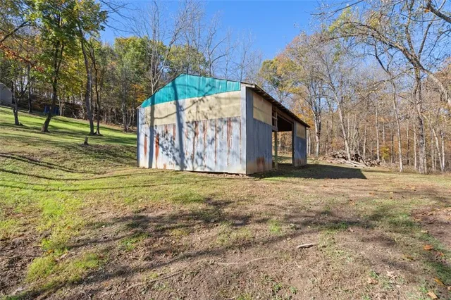 a view of a house with a yard and tree s
