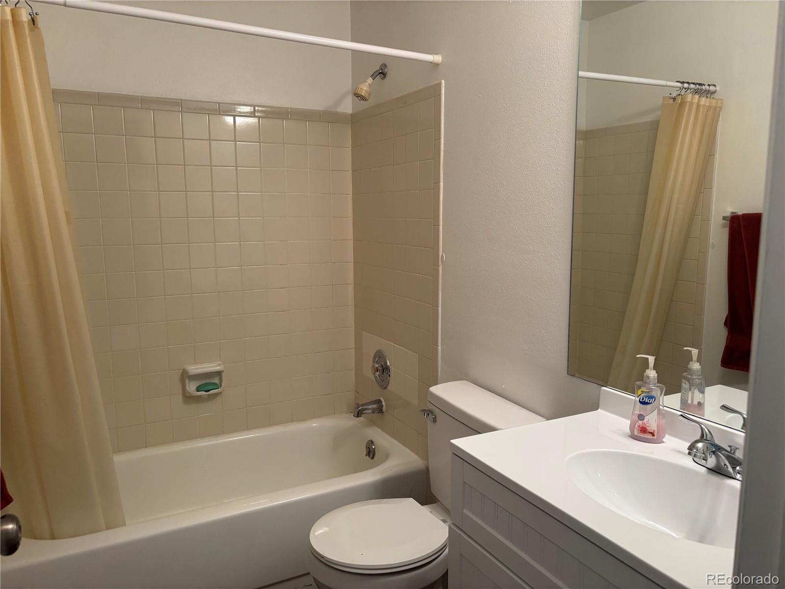 2275 South Buckley Road, Unit 101 Aurora, CO 80013 - Photo 7 of 14 a bathroom with a sink a toilet and shower