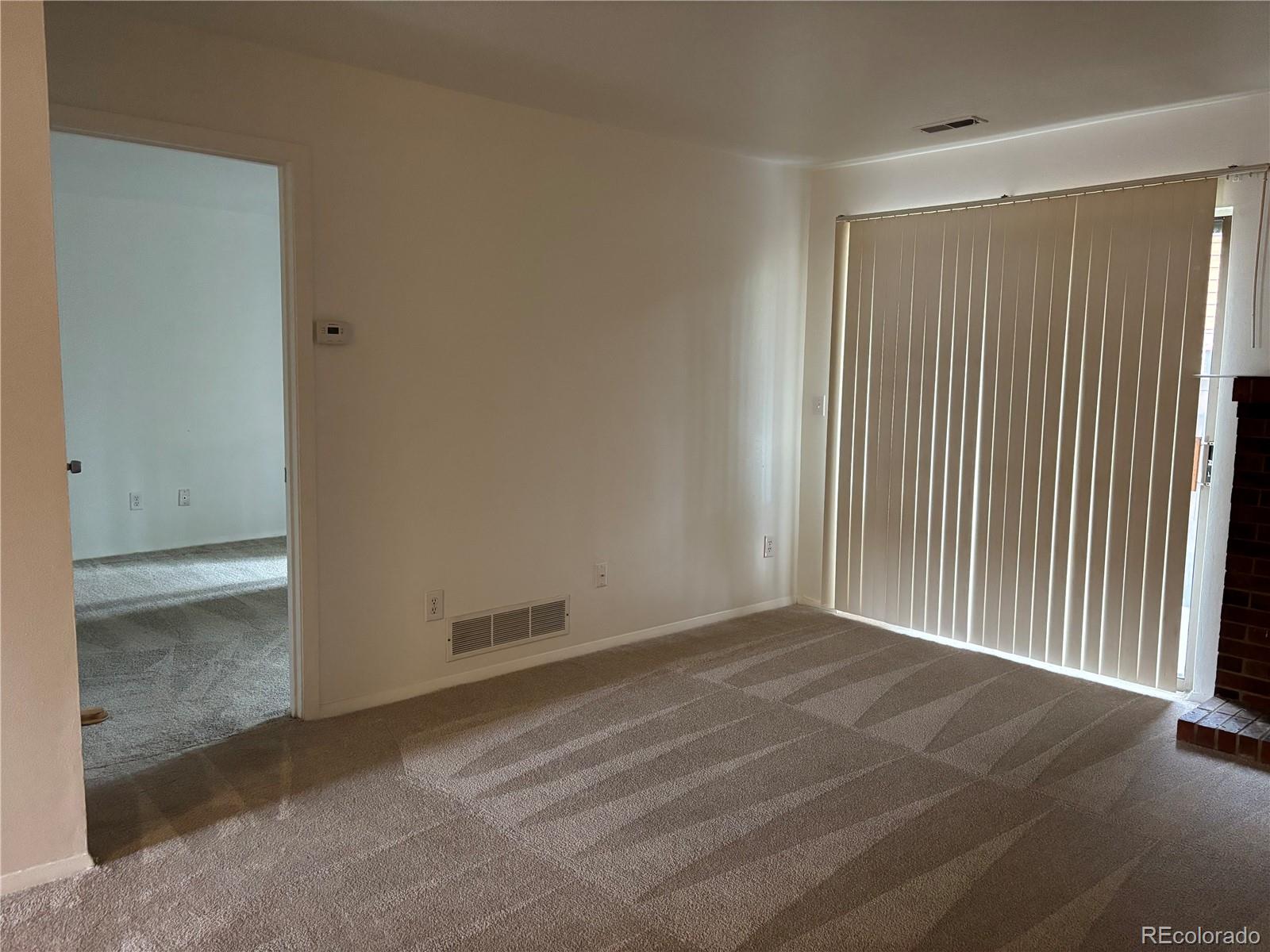 2275 South Buckley Road, Unit 101 Aurora, CO 80013 - Photo 9 of 14 an empty room with windows