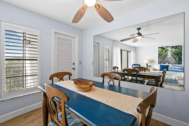 a view of a a dining room with furniture window and wooden floor