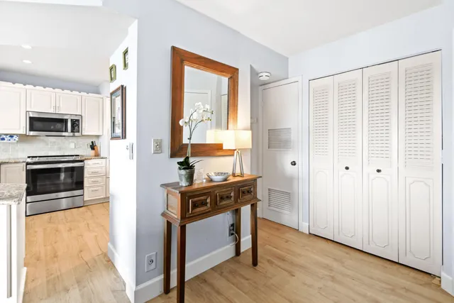 a kitchen with granite countertop a stove a sink and a refrigerator