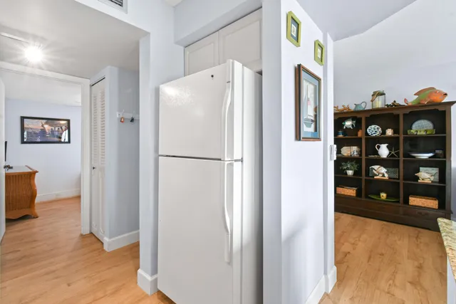 a white refrigerator freezer sitting in a kitchen