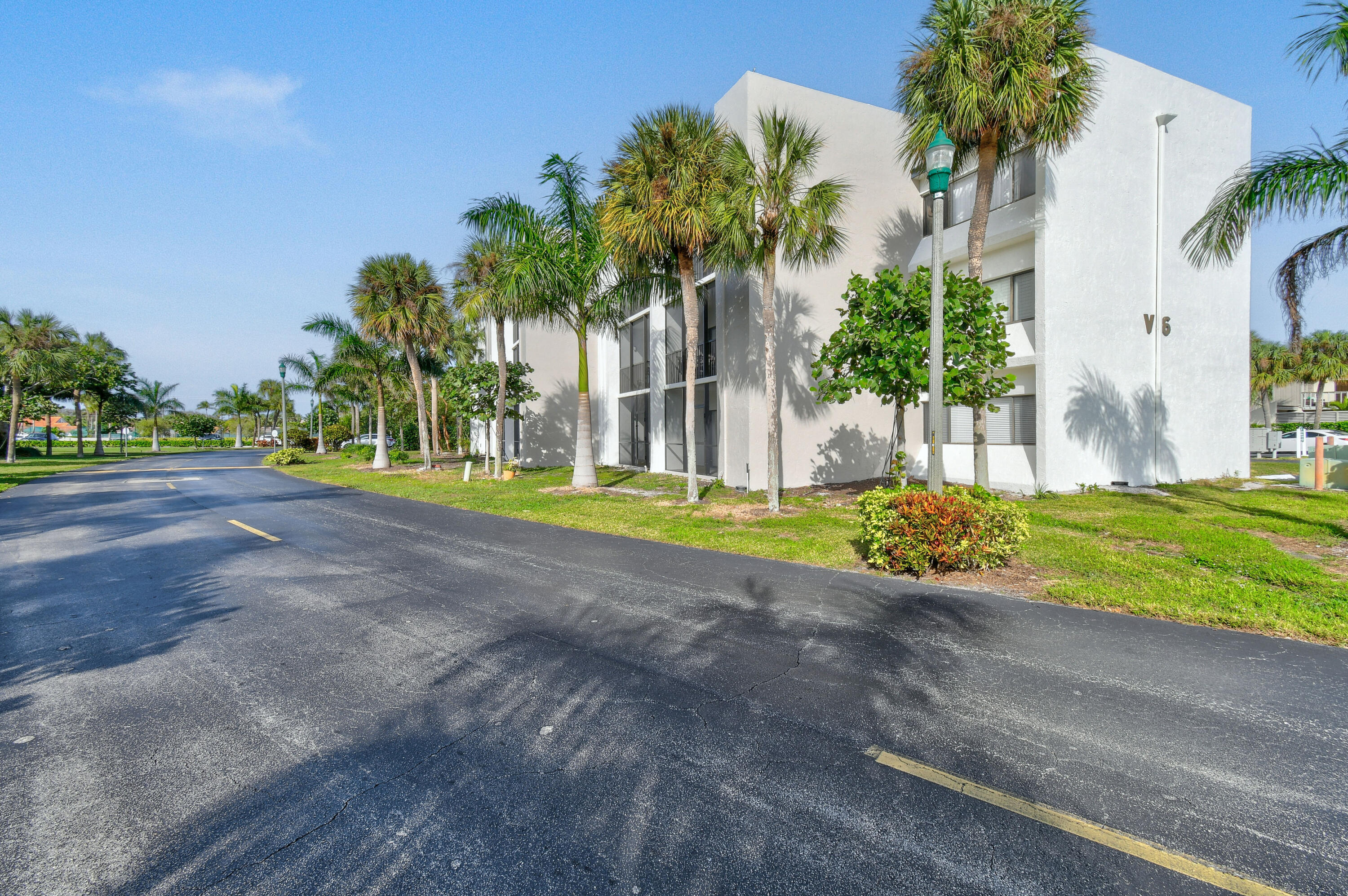 1605 Highway 1, Unit 301V6 Jupiter, FL 33477 - Photo 2 of 35 a view of a house with a big yard and palm trees