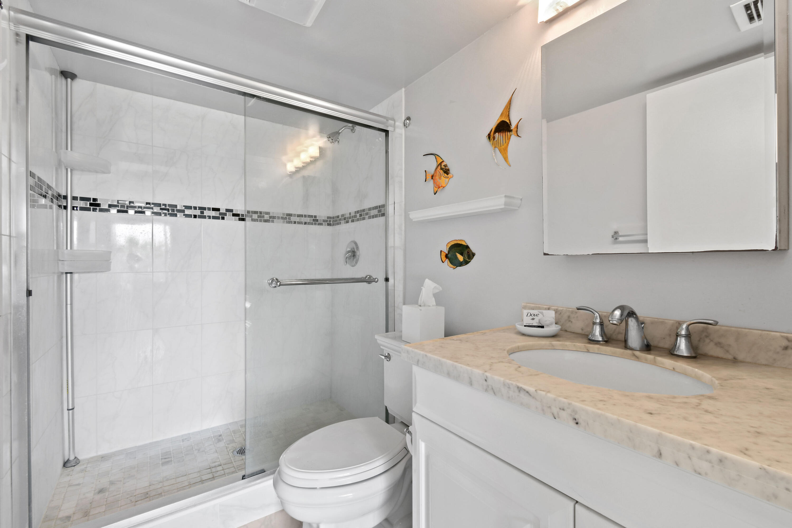 1605 Highway 1, Unit 301V6 Jupiter, FL 33477 - Photo 21 of 35 a bathroom with a granite countertop sink toilet and shower
