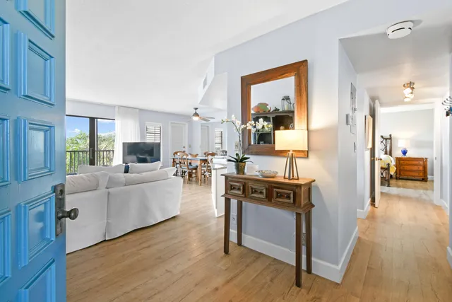 a view of living room kitchen with furniture and wooden floor