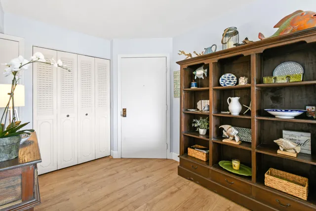 a view of workspace with wooden floor and book shelf