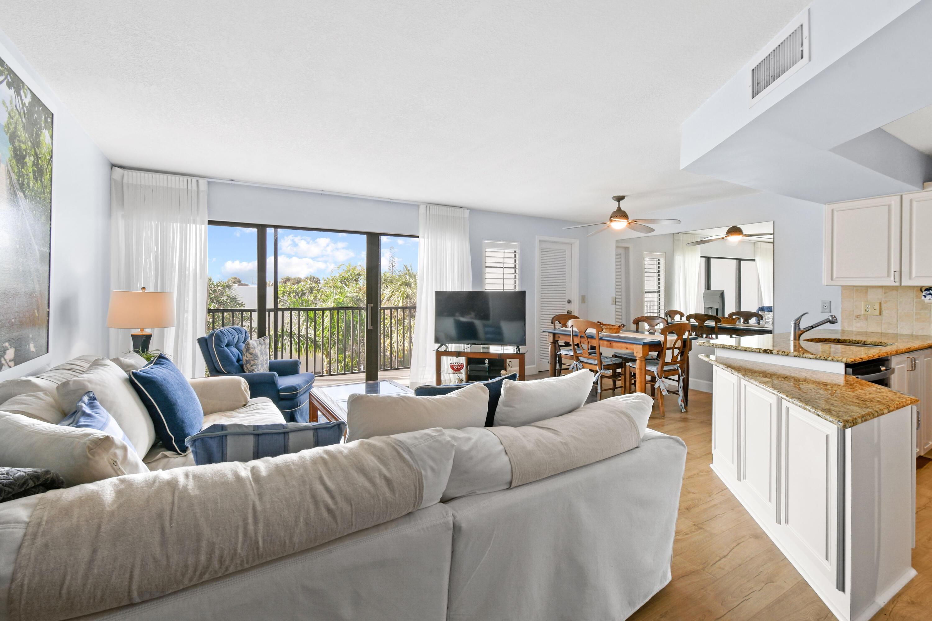 1605 Highway 1, Unit 301V6 Jupiter, FL 33477 - Photo 7 of 35 a living room with furniture large windows and a view of kitchen