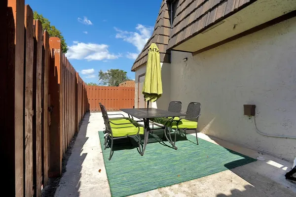 a view of balcony with chairs and a table