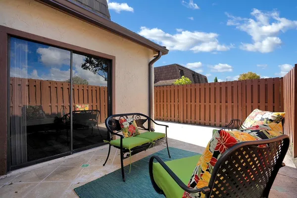 a backyard of a house with table and chairs