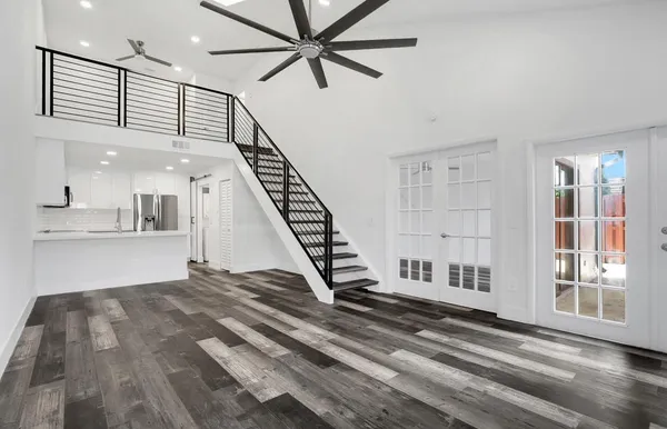 a view of entryway and hall with wooden floor