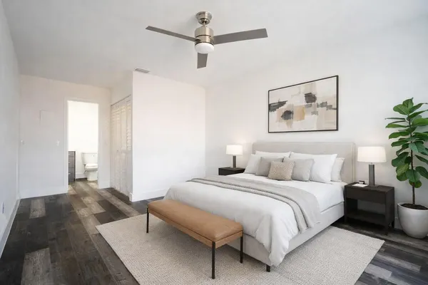 a bedroom with a large bed and a painting on the wall