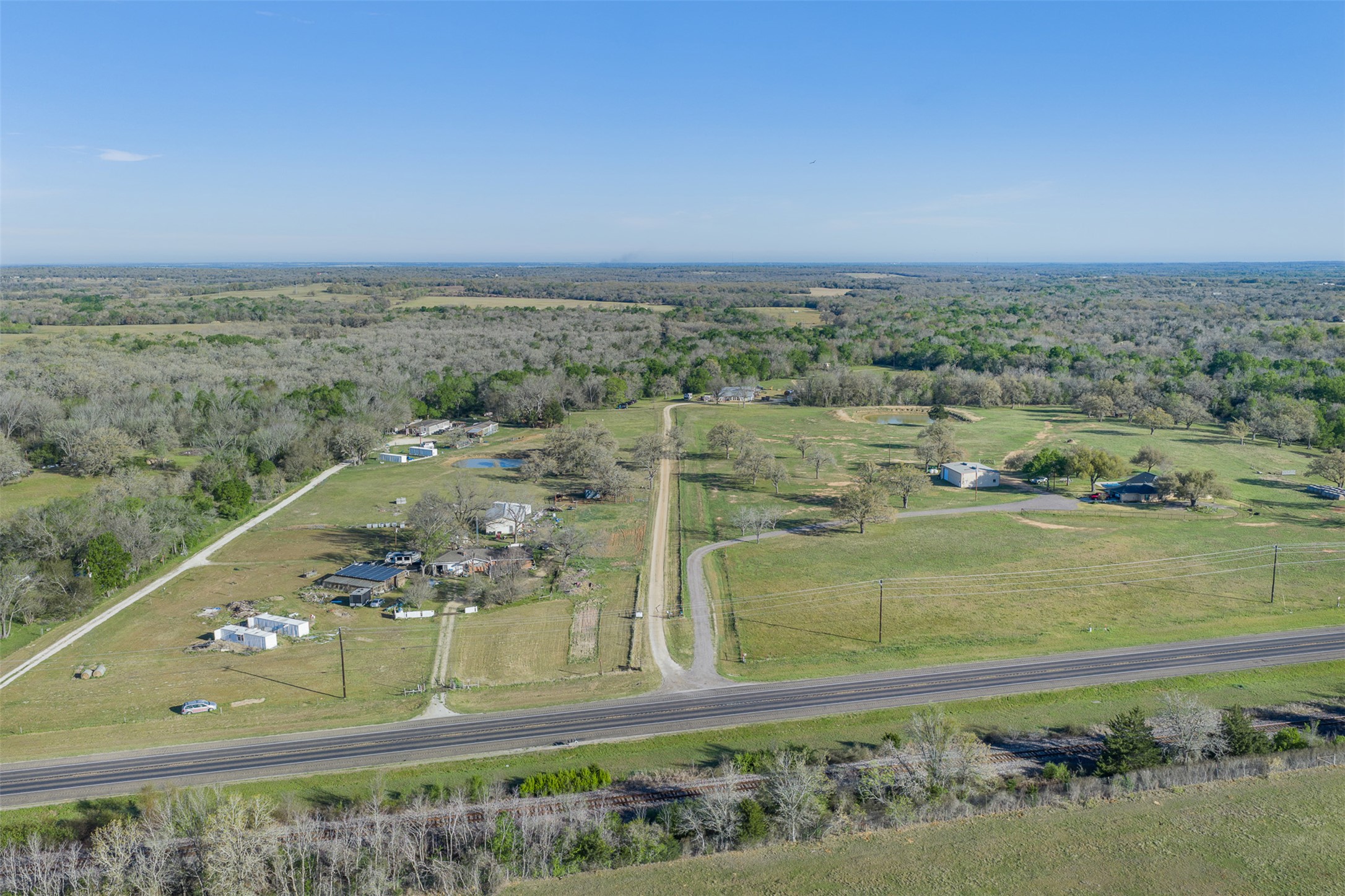 2313 Highway 79 Milano, TX 76556 - Photo 11 of 40 Expansive property featuring clearings, mature trees, and a paved road frontage