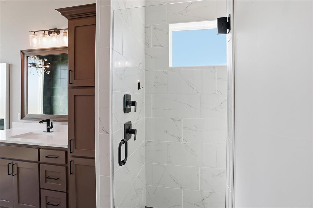 6620 Buffalo Ridge Circle Godley, TX 76044 - Photo 23 of 40 a bathroom with a shower a sink and a mirror
