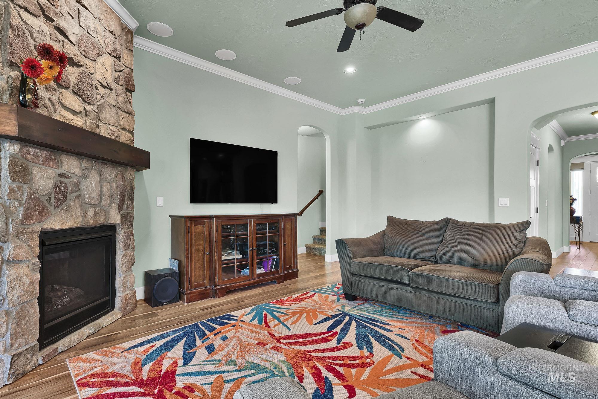 220 South Wildgrass Way Star, ID 83669 - Photo 7 of 50 Carpeted room featuring two double-hung windows with dark window treatments, light grey painted walls, and a ceiling fan with integrated lighting