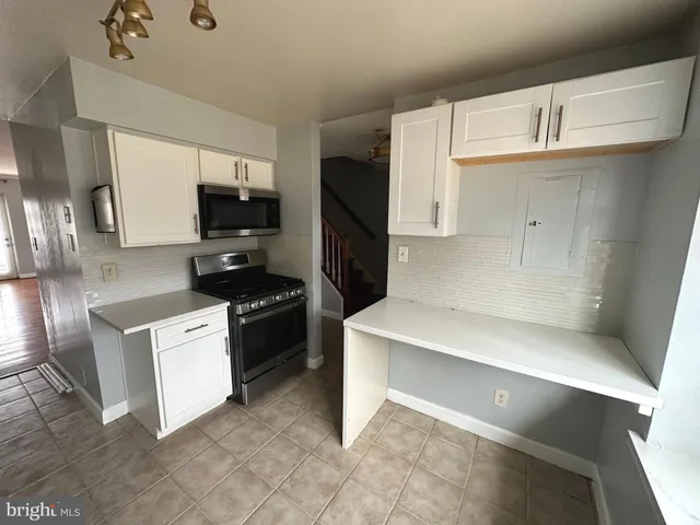 a kitchen with stainless steel appliances a refrigerator stove and microwave