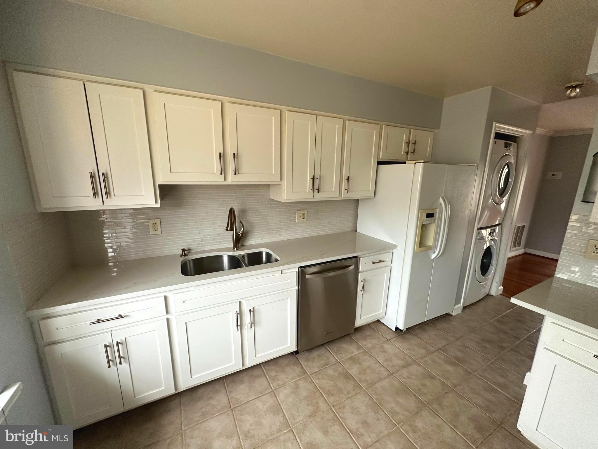 4033 Chesterwood Drive, Unit 4033 Silver Spring, MD 20906 - Photo 4 of 13 a kitchen with white cabinets and white appliances