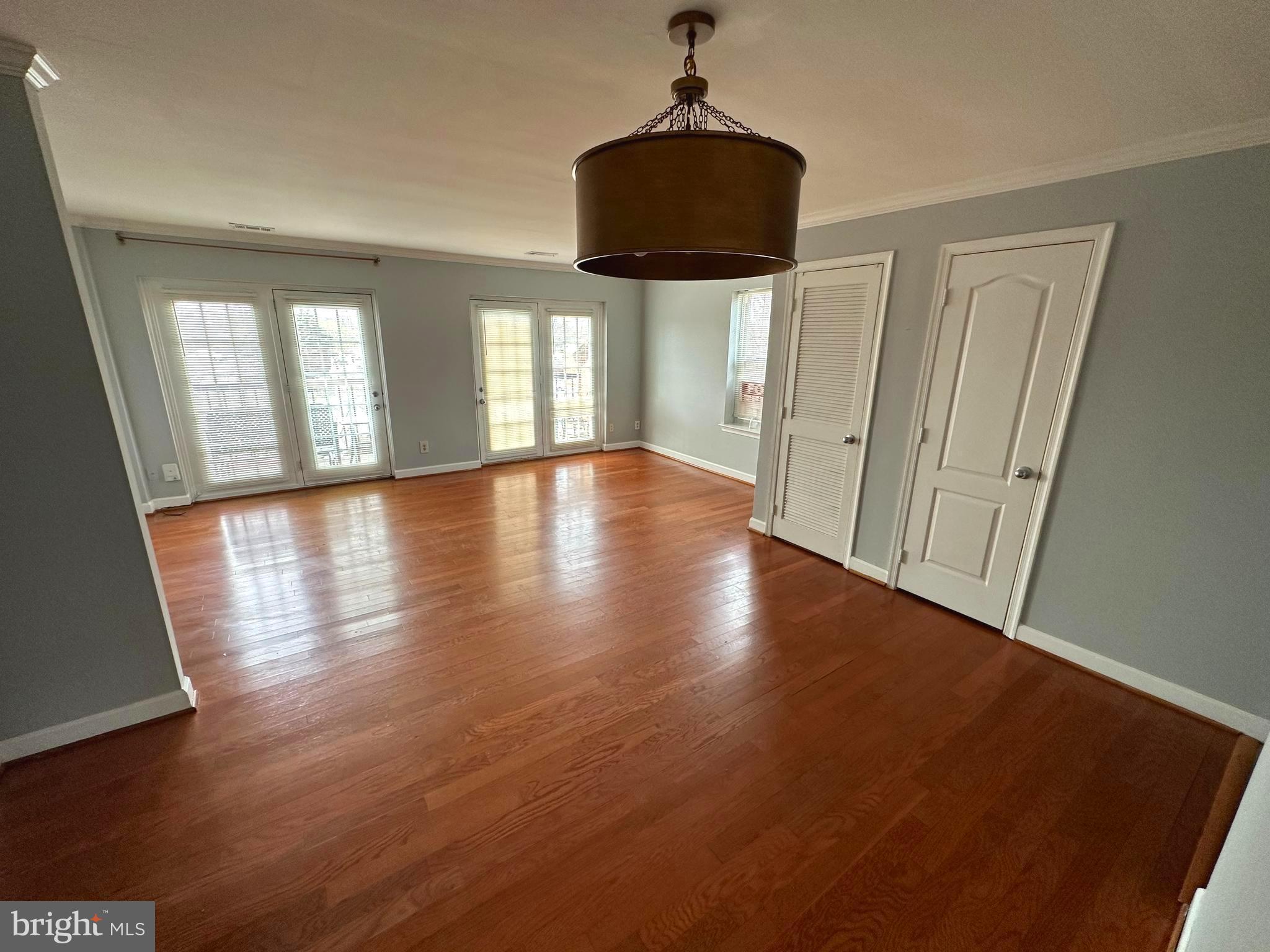 4033 Chesterwood Drive, Unit 4033 Silver Spring, MD 20906 - Photo 5 of 13 a view of empty room with wooden floor and fan
