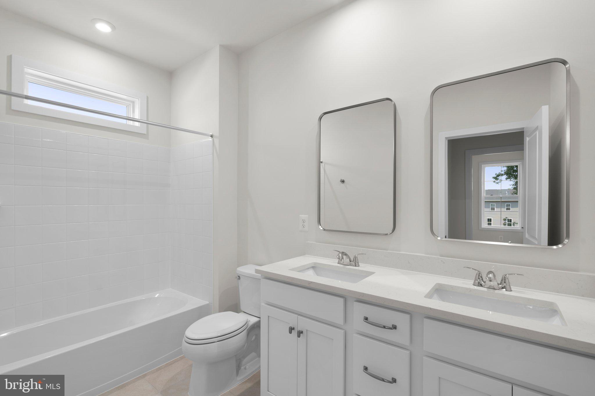 100 Alabaster Lane Stephenson, VA 22656 - Photo 21 of 44 a bathroom with a double vanity sink toilet mirror and bathtub