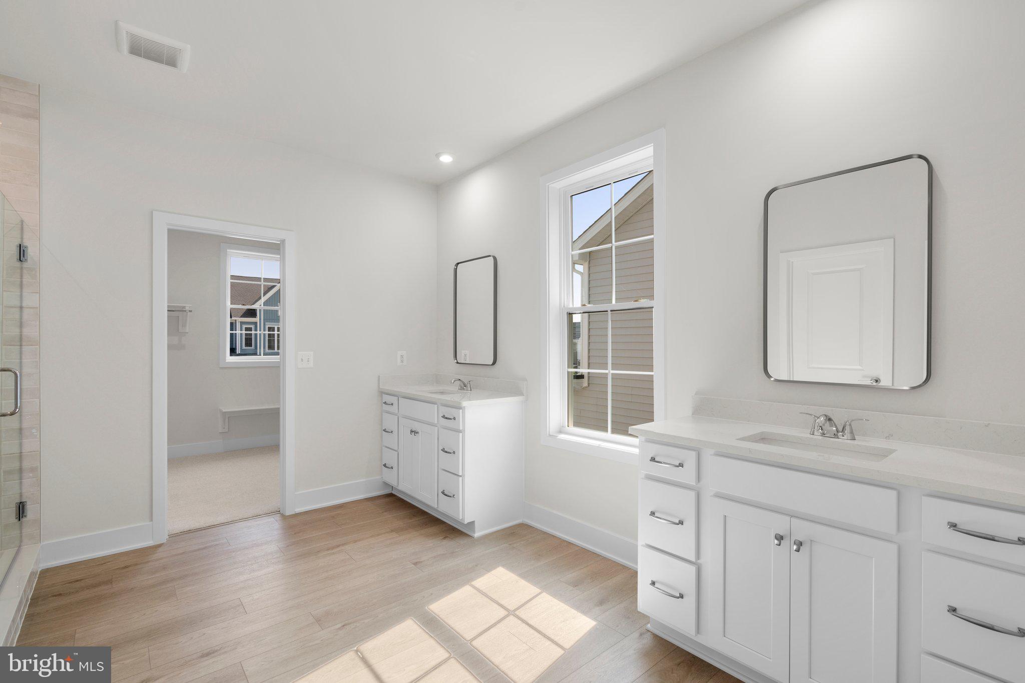 100 Alabaster Lane Stephenson, VA 22656 - Photo 26 of 44 a bathroom with a double vanity sink a mirror and a